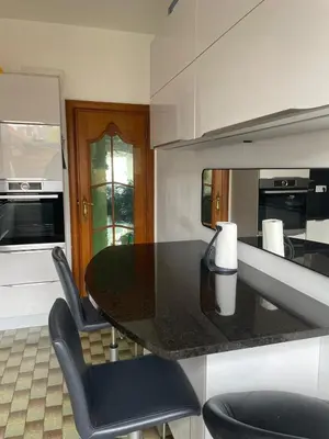 a kitchen with a black table and chairs at JV House in Zellik