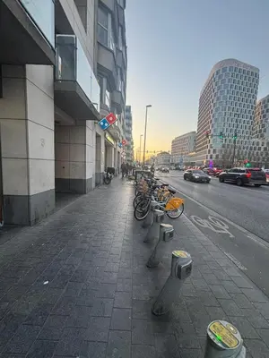 a group of bikes parked on a sidewalk next to a street at Botanical Garden Rogier Brussels in Brussels