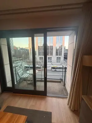 a room with a large glass door with a balcony at Botanical Garden Rogier Brussels in Brussels