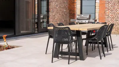 a wooden table and chairs on a patio at Gezellig vakantiehuis voor 12 personen in Boutersem