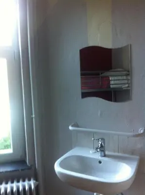 a white sink in a bathroom with a mirror at The82 Hostel Louise in Brussels
