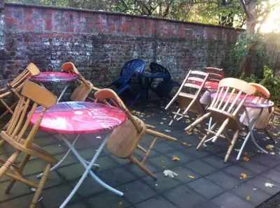 a group of chairs and tables on a patio at The82 Hostel Louise in Brussels