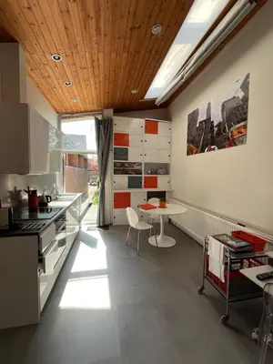 a kitchen with a table and a dining room at Studio vintage banlieue BXL in Genval