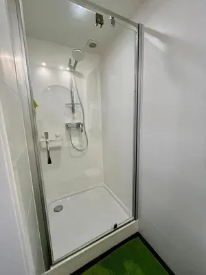 a shower with a glass door in a bathroom at Studio vintage banlieue BXL in Genval