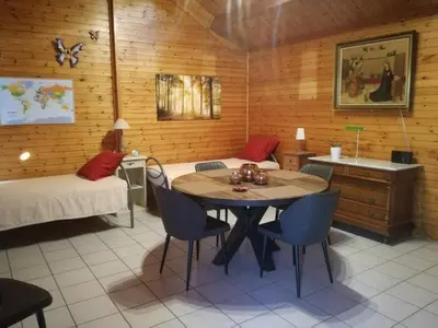 a room with a bed and a table and chairs at De Zon B&B in Heist-op-den-Berg
