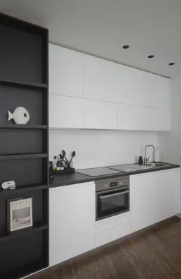 a kitchen with white and black counters and a sink at Appartement t'Zuid with underground parking in Antwerp