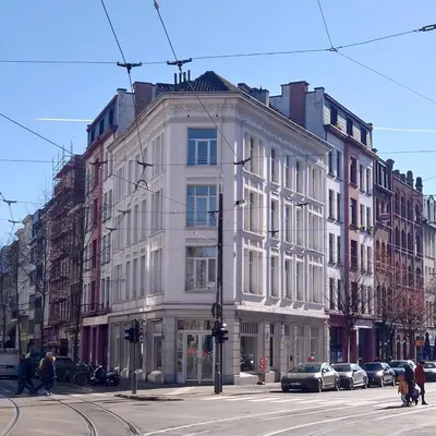 a white building on the corner of a street at Appartement t'Zuid with underground parking in Antwerp