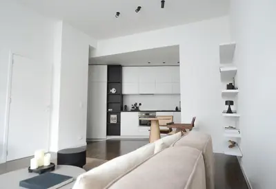 a living room with a couch and a kitchen at Appartement t'Zuid with underground parking in Antwerp
