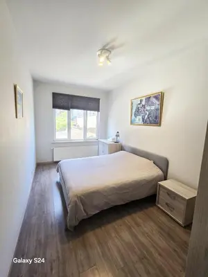 a bedroom with a large bed and a window at Splendid 2 bedroom apartment in Etterbeek in Brussels