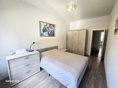 a bedroom with a bed and a dresser with a lamp at Splendid 2 bedroom apartment in Etterbeek in Brussels