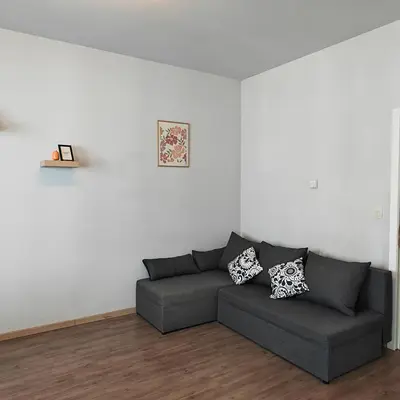 a living room with a gray couch in a white room at Splendid 2 bedroom apartment in Etterbeek in Brussels