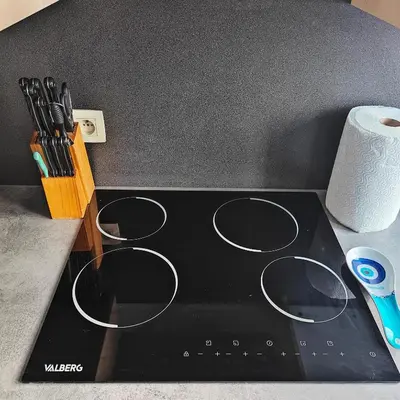 a black stove top with a roll of paper towels at Splendid 2 bedroom apartment in Etterbeek in Brussels