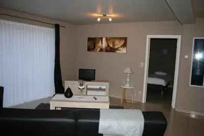 a living room with a couch and a table at Apartment Fruithof Tack in Sint-Gillis-Waas