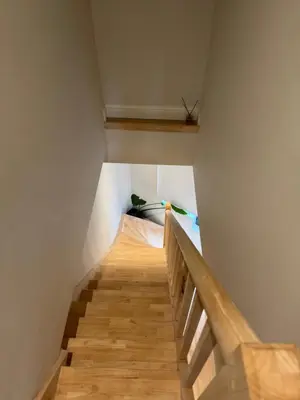 a staircase in a room with wooden floors and ceilings at Holiday Small Shared Room in Gent in Ghent