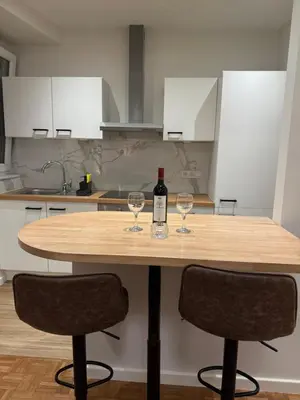 a wooden table with two glasses of wine on it at Arm Apart in Brussels