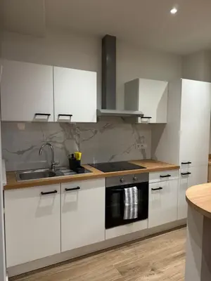 a kitchen with white cabinets and a sink at Arm Apart in Brussels