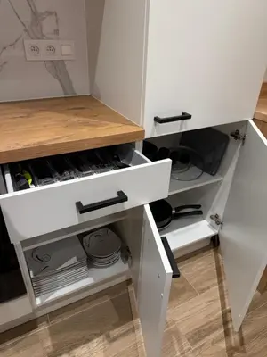 a white kitchen with white drawers at Arm Apart in Brussels