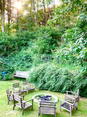 a group of park benches sitting around a fire pit at Family home, green surroundings, 10 min from Brussels in Overijse