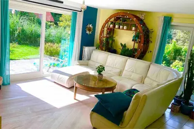 a living room with a white couch and a table at Family home, green surroundings, 10 min from Brussels in Overijse