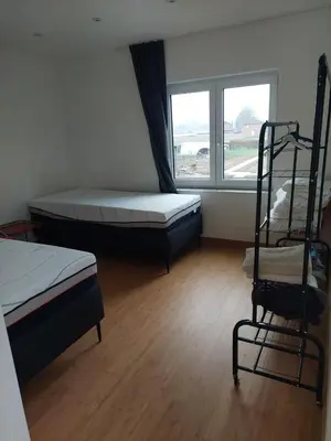 a room with two beds and a ladder and a window at Krie 2 by Luttelkolen in Tielt