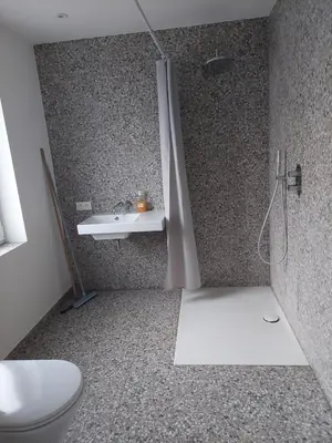 a bathroom with a shower and a toilet and a sink at Krie 2 by Luttelkolen in Tielt