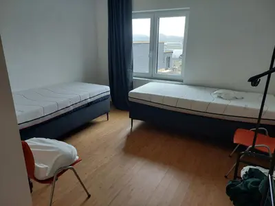 a bedroom with two beds and a window at Krie 2 by Luttelkolen in Tielt