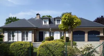a house with a black roof at Apartment in a villa in Kasterlee
