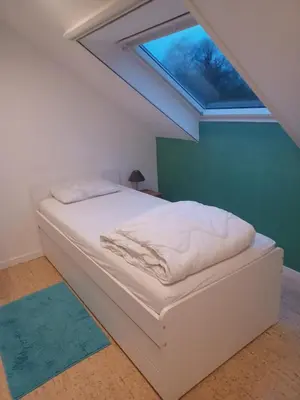 a white bed in a room with a skylight at Apartment in a villa in Kasterlee