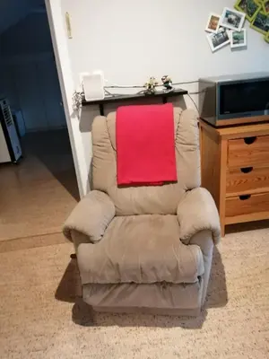 a brown chair with a red towel on it at Apartment in a villa in Kasterlee