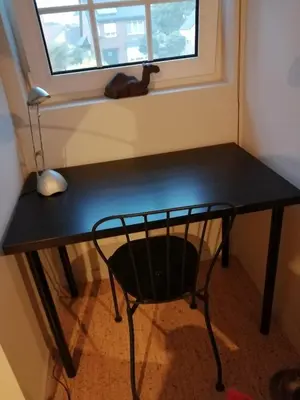 a black desk in a room with a window at Apartment in a villa in Kasterlee
