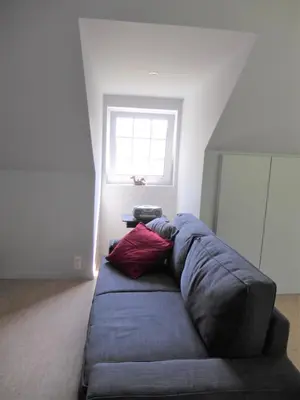 a couch in a living room with a window at Apartment in a villa in Kasterlee
