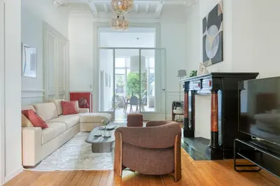 a living room with a couch and a tv at Mas Europe by Sweett in Brussels