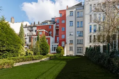 a grassy yard in front of buildings at Mas Europe by Sweett in Brussels