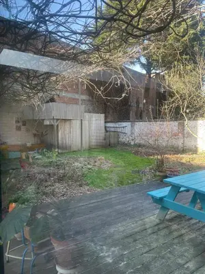 a blue picnic table in a yard with a fence at Spacious house with big garden close to the city in Ghent