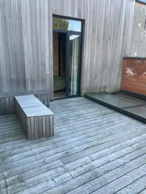 a room with a bench on a wooden floor at Spacious house with big garden close to the city in Ghent