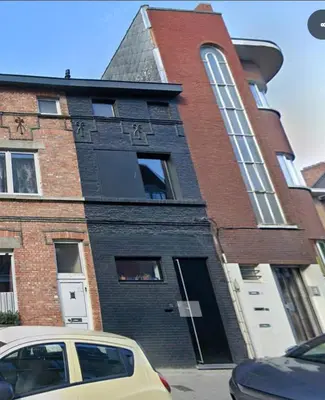 a building with a car parked in front of it at Spacious house with big garden close to the city in Ghent
