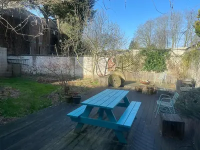 a blue picnic table in the middle of a yard at Spacious house with big garden close to the city in Ghent