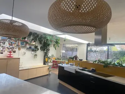 a kitchen with two large pendant lights over a counter at Spacious house with big garden close to the city in Ghent