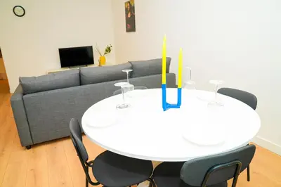 a living room with a white table and a couch at Lovely 1BR & 1LR Apt for 4P, Only 15 Min Walk to City Center in Ghent