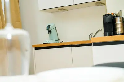 a kitchen counter with a coffee maker on top of it at Lovely 1BR & 1LR Apt for 4P, Only 15 Min Walk to City Center in Ghent