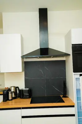 a kitchen with a black hood over a stove at Lovely 1BR & 1LR Apt for 4P, Only 15 Min Walk to City Center in Ghent