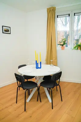 a white table with four chairs and candles on it at Lovely 1BR & 1LR Apt for 4P, Only 15 Min Walk to City Center in Ghent