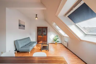 a living room with a couch and a window at Bright and Central Antwerp Apartments in Antwerp
