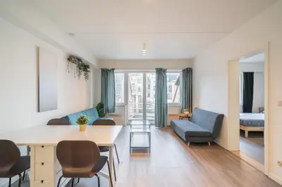 a living room with a table and a couch at Bright and Central Antwerp Apartments in Antwerp