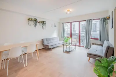 a living room with a table and chairs and a couch at Bright and Central Antwerp Apartments in Antwerp
