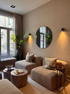 a living room with a couch and a mirror at Holiday Home in Antwerp in Antwerp