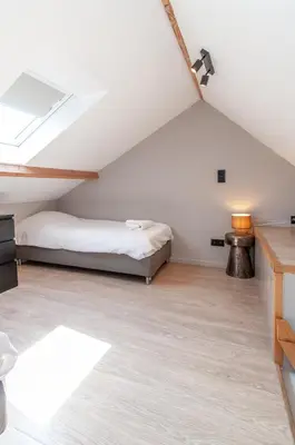 a attic bedroom with a bed and a skylight at Holiday Home in Antwerp in Antwerp