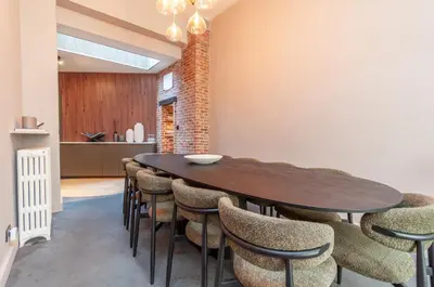 a dining room with a wooden table and chairs at Holiday Home in Antwerp in Antwerp