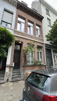 a car parked in front of a brick house at Holiday Home in Antwerp in Antwerp