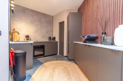 a kitchen with gray cabinets and a counter top at Holiday Home in Antwerp in Antwerp